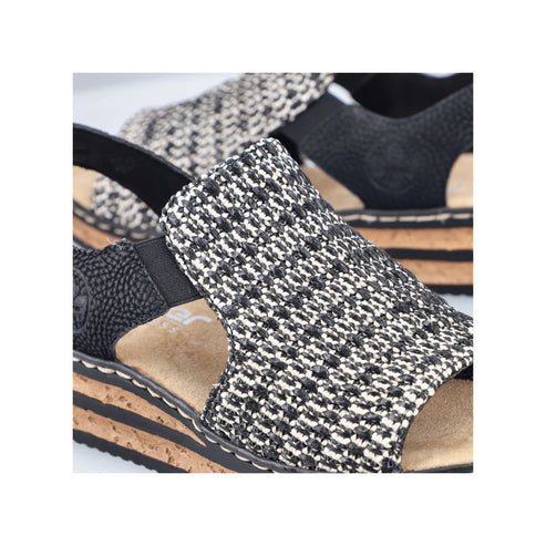 Close-up of a black and white woven sandal with a cork sole.