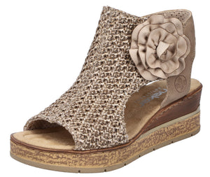 Beige peep-toe wedge sandal with flower accent and textured upper.