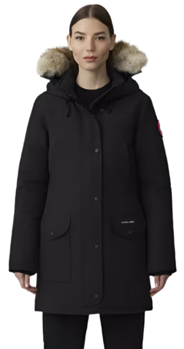 A woman wears a black winter coat with a fur-trimmed hood.