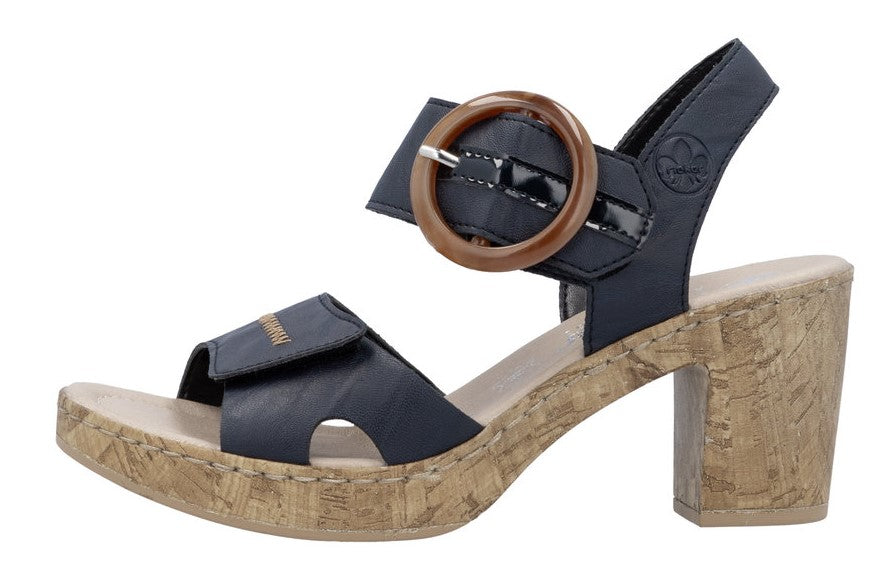 Navy sandal with a cork block heel and oversized circular buckle.