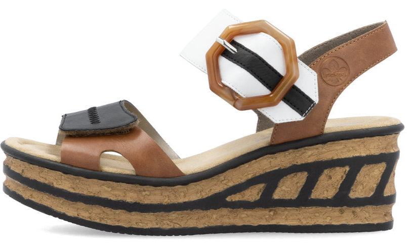 Platform sandal with tan brown, black, and white straps and buckle detail.