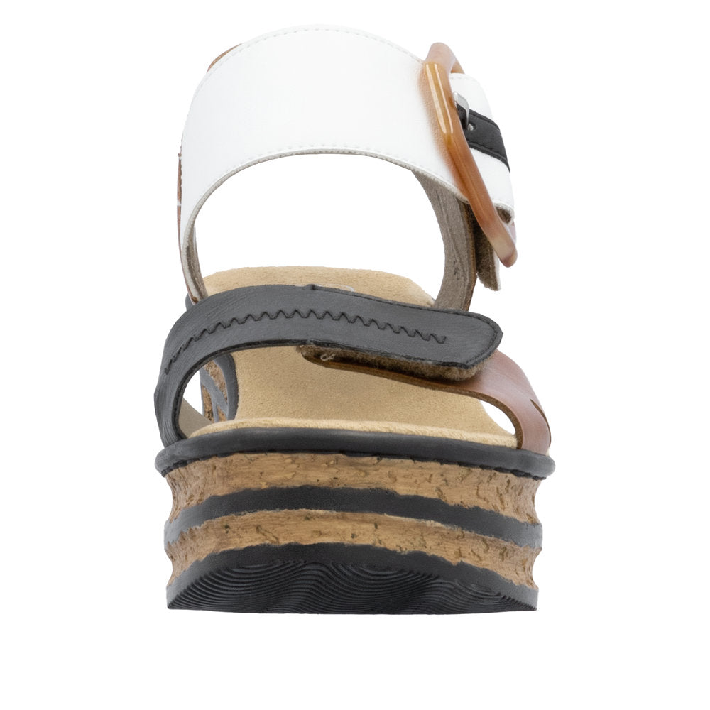 Platform sandal with white, black, and brown straps, and cork midsole.