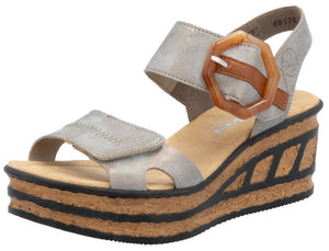 Silver platform sandal with adjustable hook-and-loop straps and oversized decorative buckle.