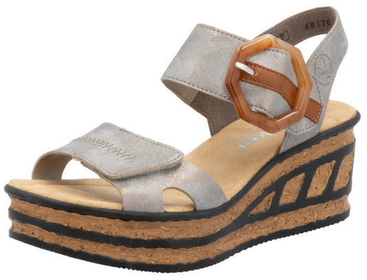 Silver platform sandal with adjustable hook-and-loop straps and oversized decorative buckle.