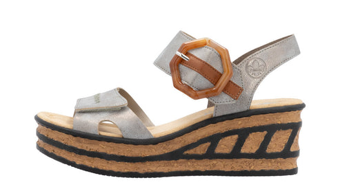 Silver wedge platform sandal with cork texture midsole and a decorative buckle.