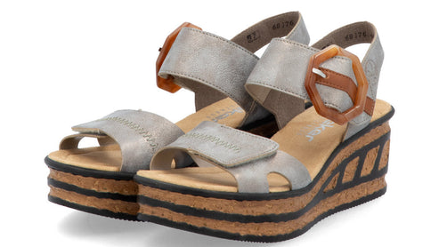 Silver platform sandals with thick straps and orange buckle.