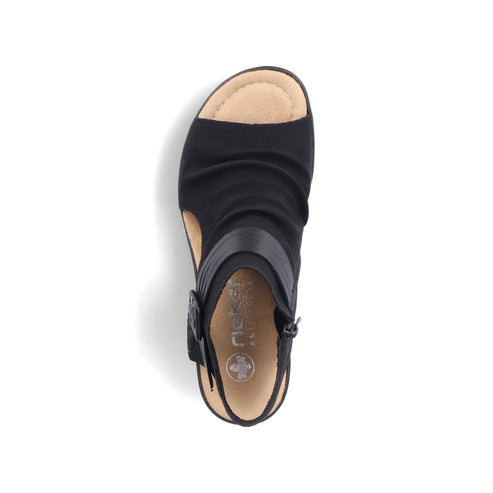 Overhead view of a black sandal with leather accents, beige sole, and side zipper.