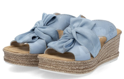 Two light blue wedge sandals with fabric knots on the straps and woven platforms.