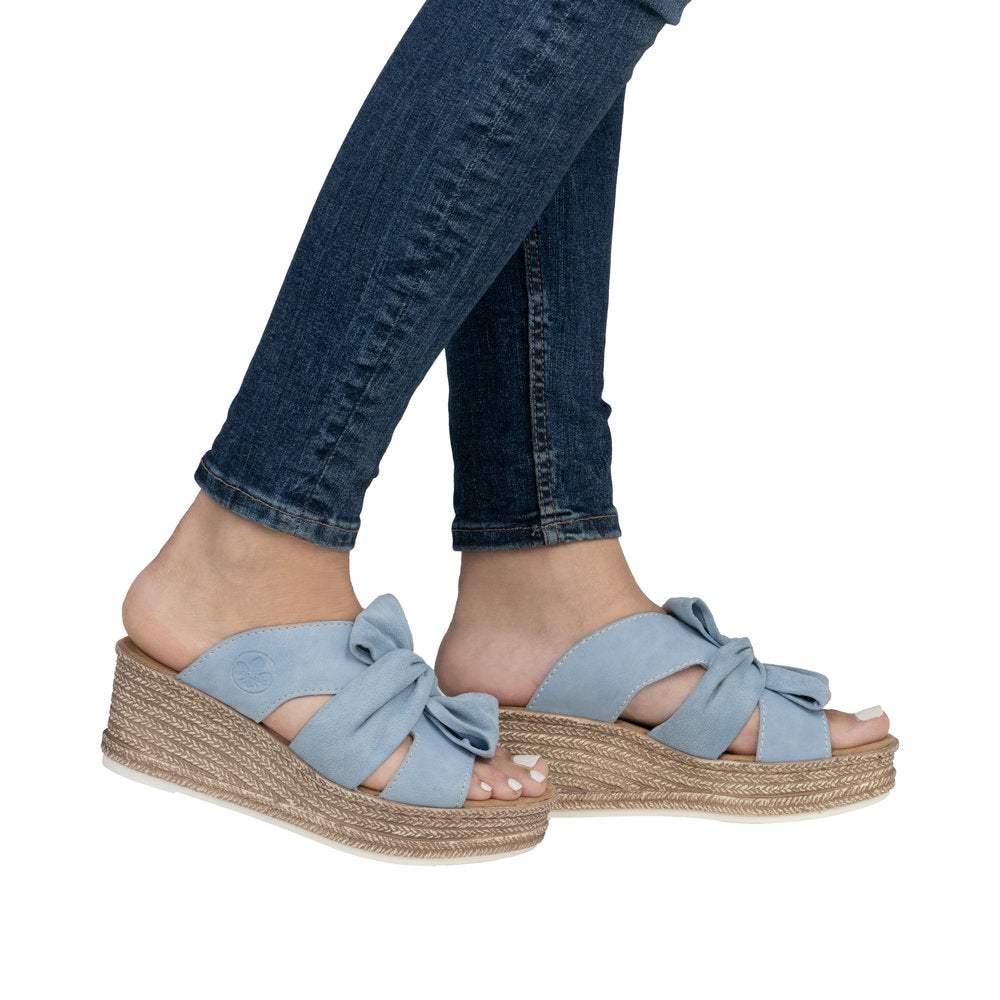 Light blue wedge sandals with a bow detail on the upper.