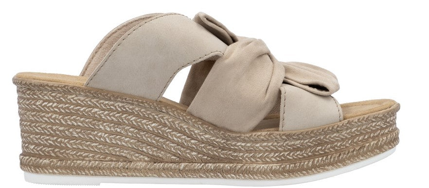 Platform sandal with tan knotted straps and a woven wedge heel.