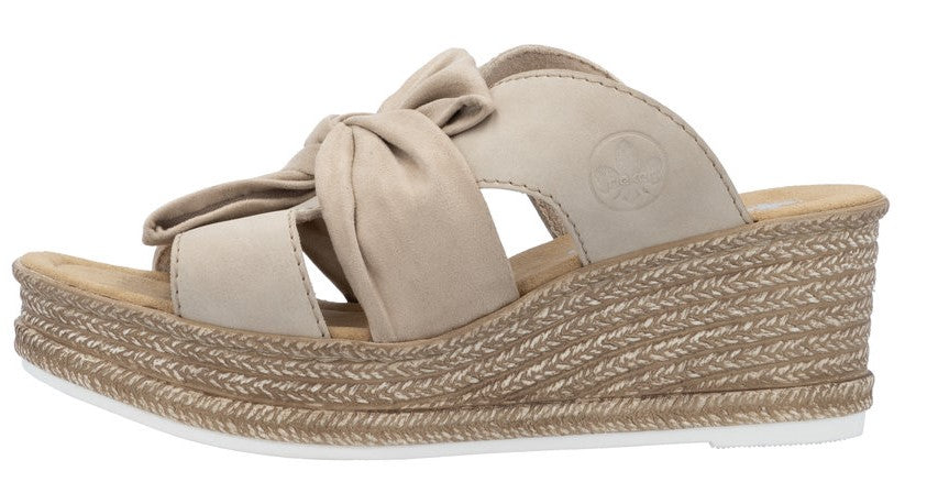 Wedge sandal with knotted beige straps and a woven espadrille-style platform.