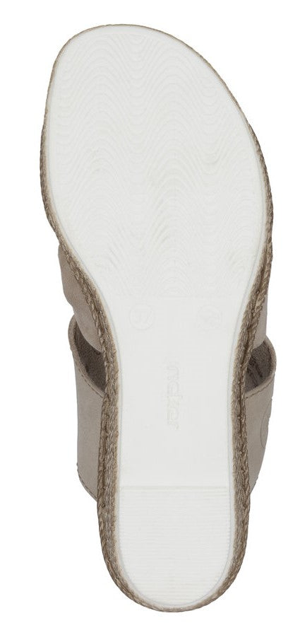 A beige sandal with two straps and a white sole.