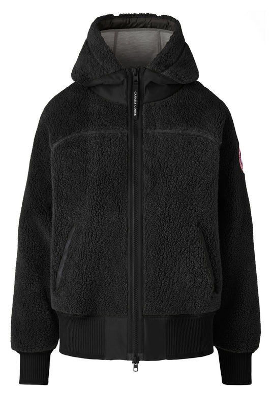 Black fuzzy jacket with hood and zipper.