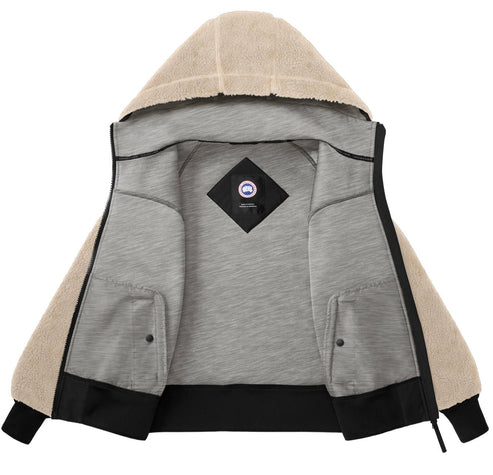 Open beige sherpa-lined hoodie with gray interior and a centered logo patch.