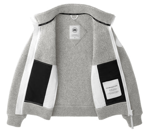 Open light gray full-zip sweater with contrasting white zipper and pocket liners, along with black pocket accents; the left pocket is labeled 'HUMANATURE'.