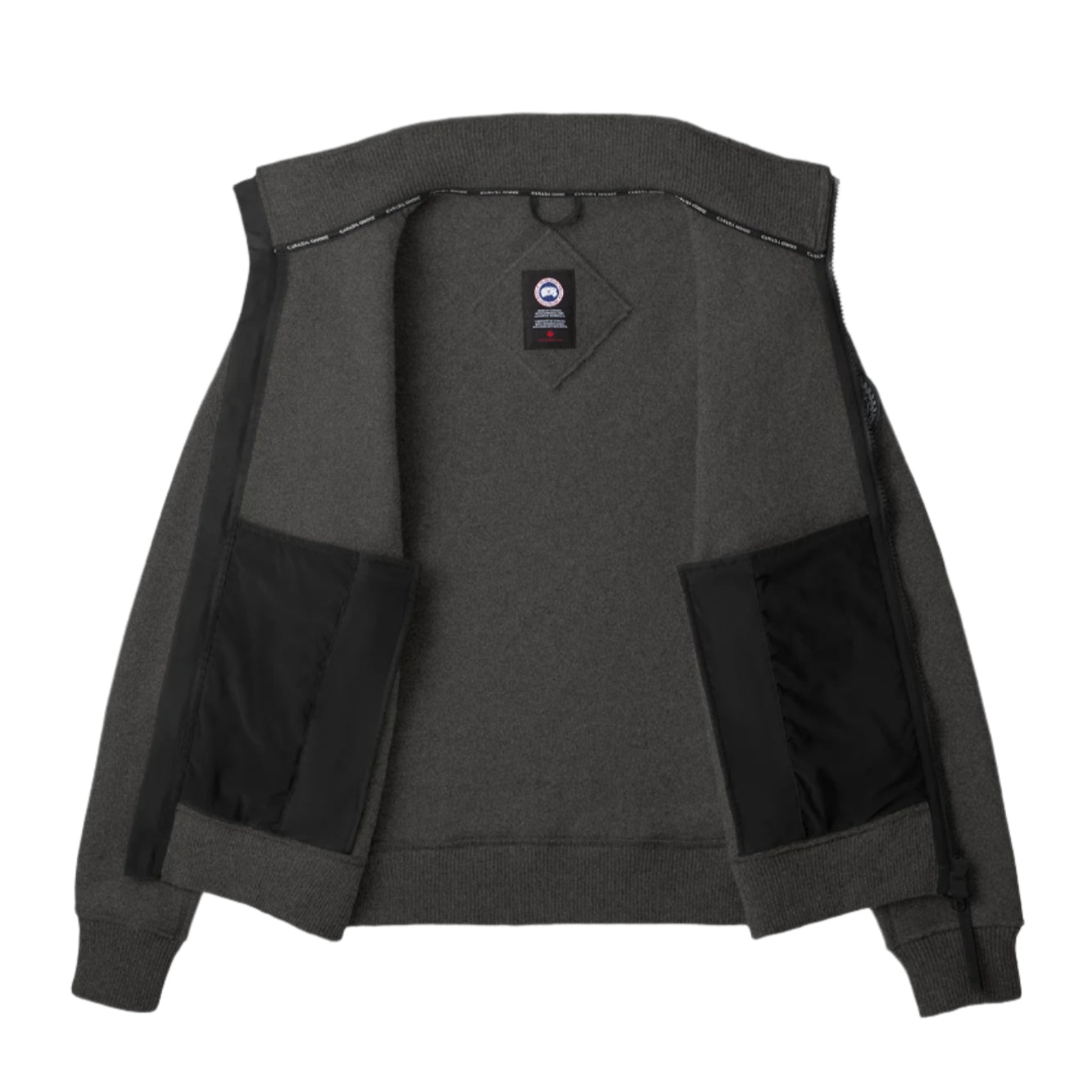 Opened charcoal zip-up jacket with Canada Goose badge and two inner pockets.