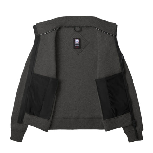 Opened charcoal zip-up jacket with Canada Goose badge and two inner pockets.