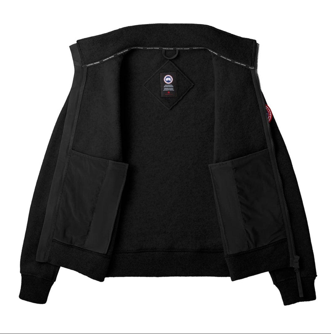 Open black jacket featuring inner pockets and the Canada Goose logo.