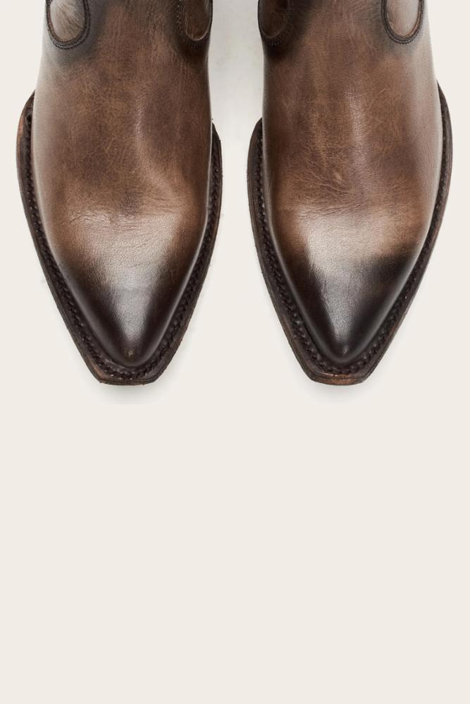 Two brown leather cowboy boot tips.