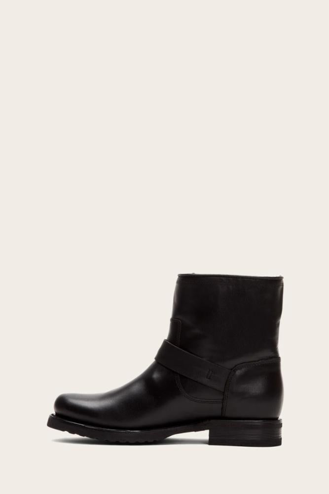 Black leather ankle boot with a rounded square toe and a strap around the ankle.