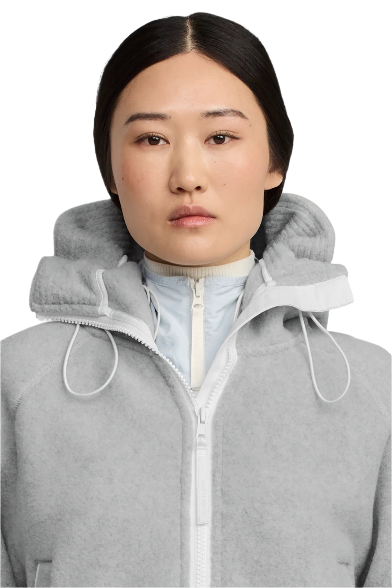 Close-up of a person with a gray hooded zipper jacket.