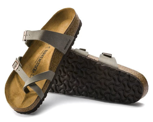 Pair of toe-loop sandals, one resting atop the other, revealing a tan sole and dark outsole, adjustable straps with buckles.