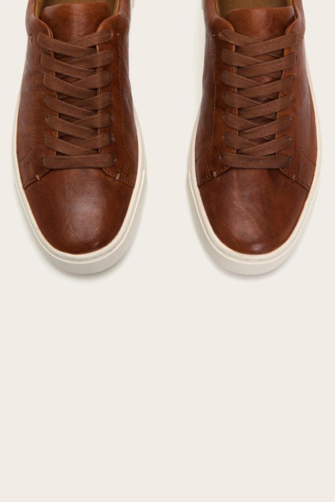 Pair of brown leather shoes with white soles, seen from above.