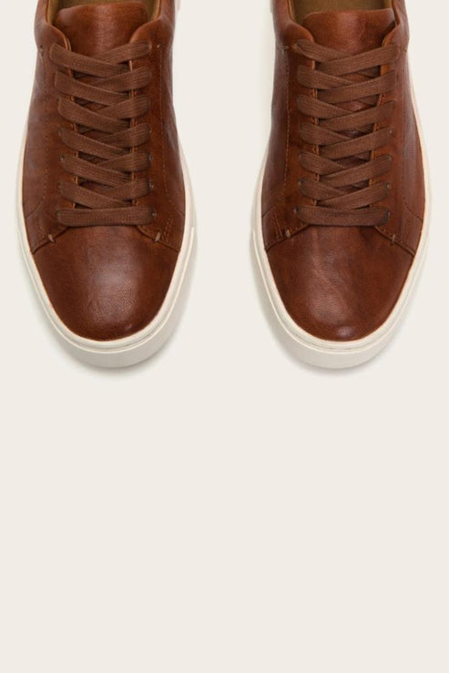 Pair of brown leather shoes with white soles, seen from above.