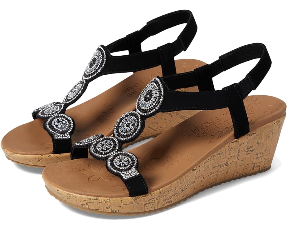 Black wedge sandals with beaded circular embellishments.