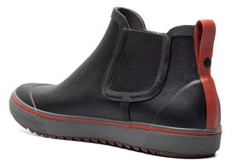 Black Chelsea boot with red heel pull tab and gray sole.