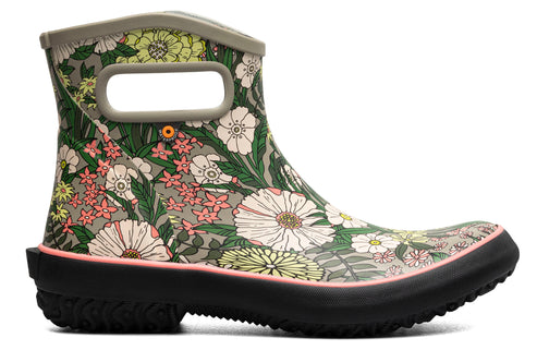 Ankle-high boot with floral design, pull tab, and pink sole.
