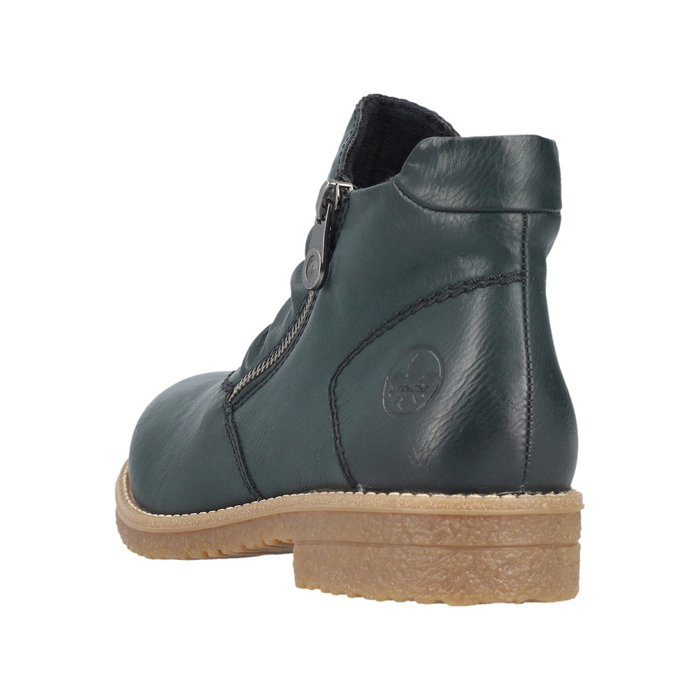 Green leather ankle boot with zipper and beige sole.