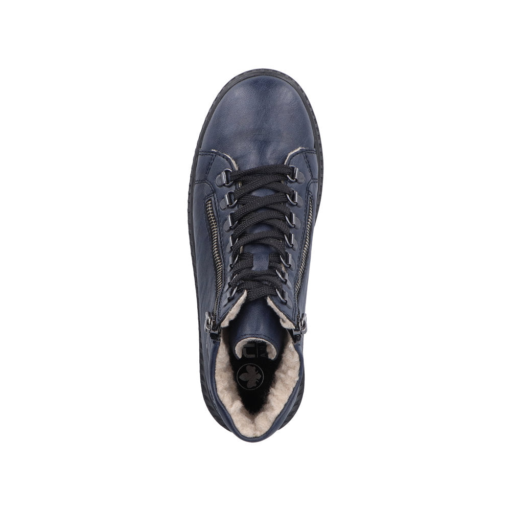 Top-down view of a blue, high-top shoe with laces and zippers and a visible faux fur lining.