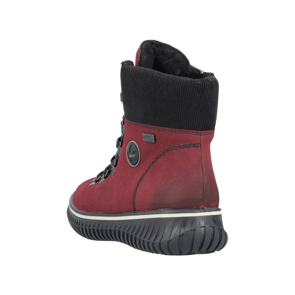 Back view of a red boot with black trim, featuring a padded collar and lug sole.