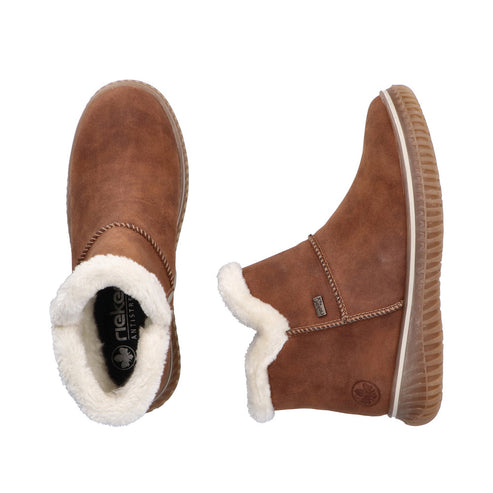 Two brown faux leather ankle boots with white faux fur trim and treaded soles.