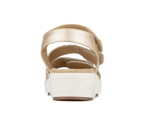 Gold, back view of platform sandals with adjustable hook and loop straps.