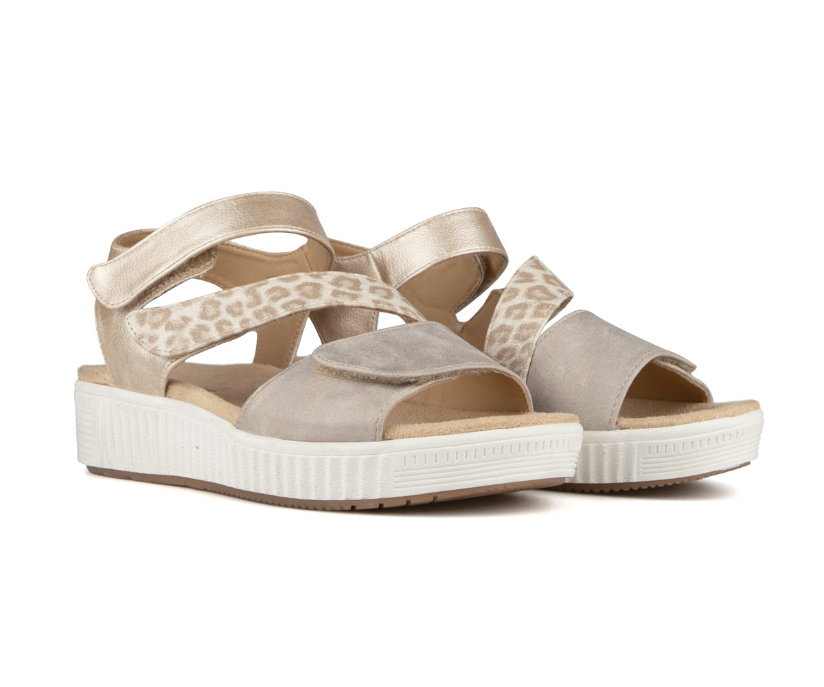 Two platform sandals with velcro closures, one tan and gold, the other grey and gold.