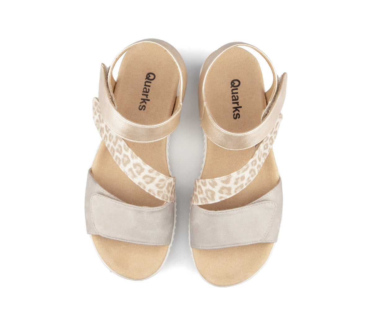 Pair of sandals with beige, gold and leopard print straps.