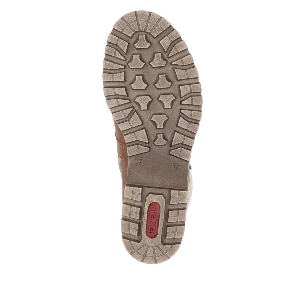 Tan boot sole with geometric tread pattern.