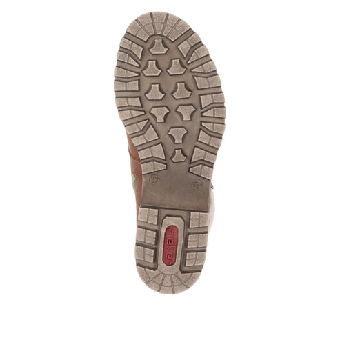 Tan boot sole with geometric tread pattern.