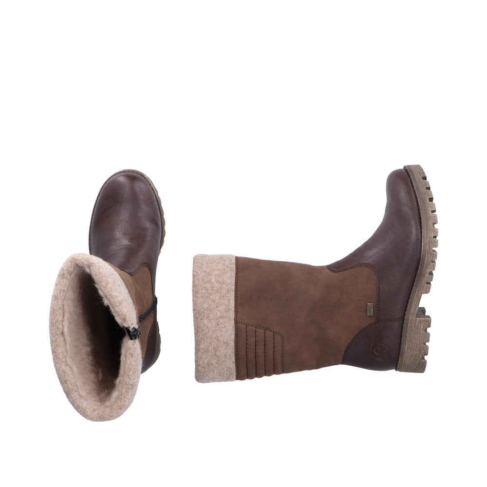 Pair of brown boots with faux fur lining and lug soles.
