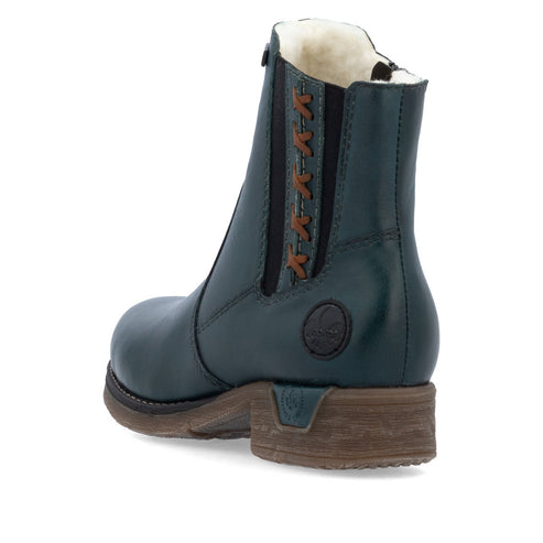 Dark teal ankle boot with a faux fur lining and brown heel.