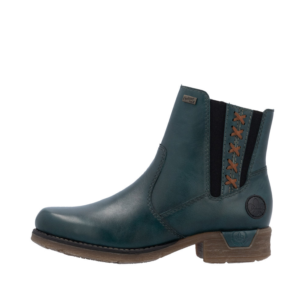 Teal leather Chelsea boot with dark elastic side panel and decorative brown stitched pattern.