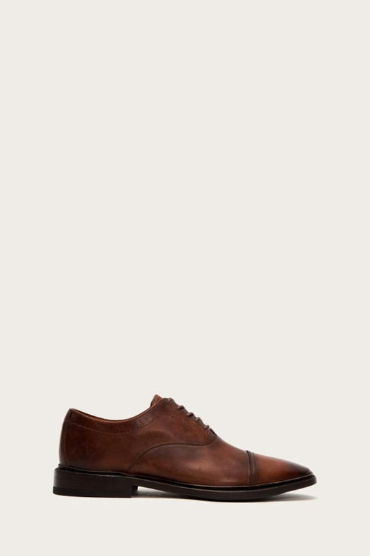 Brown leather cap-toe dress shoe.