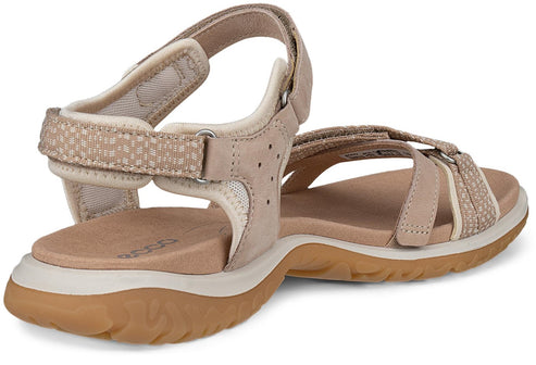 Beige sandal with adjustable straps and textured accents.