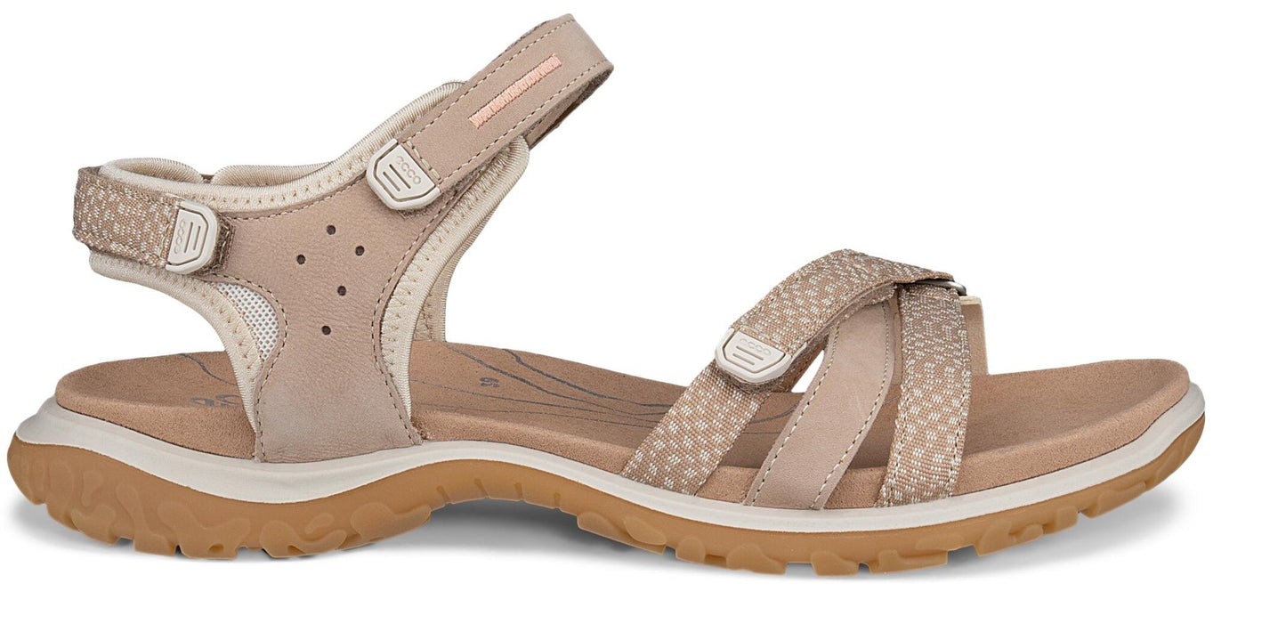 Beige criss-cross strap sandal with velcro closures.