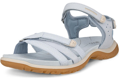 Light blue sandal with adjustable velcro straps and a brown sole.