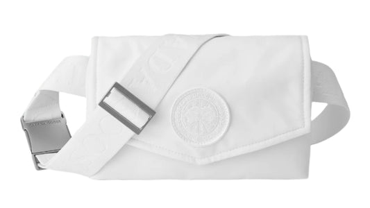 White fanny pack with an adjustable strap and a square buckle. An emblem on the flap of the bag.