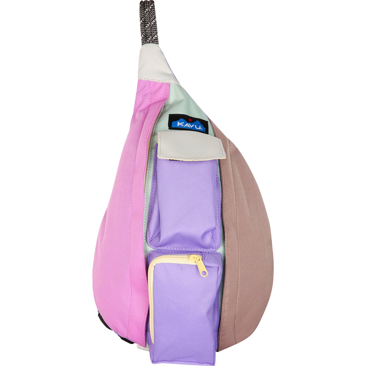 Sling bag with pink, lavender, beige, and light green panels, two lavender front pockets, and the Kavu logo near the strap.