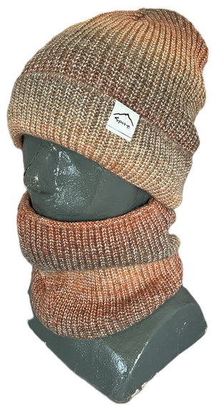 A ribbed knit beanie and matching neck warmer in a heathered, multi-tonal mix of brown, orange, and tan, shown on a gray mannequin bust with a small rectangular white tag on the beanie featuring a mountain graphic and text.